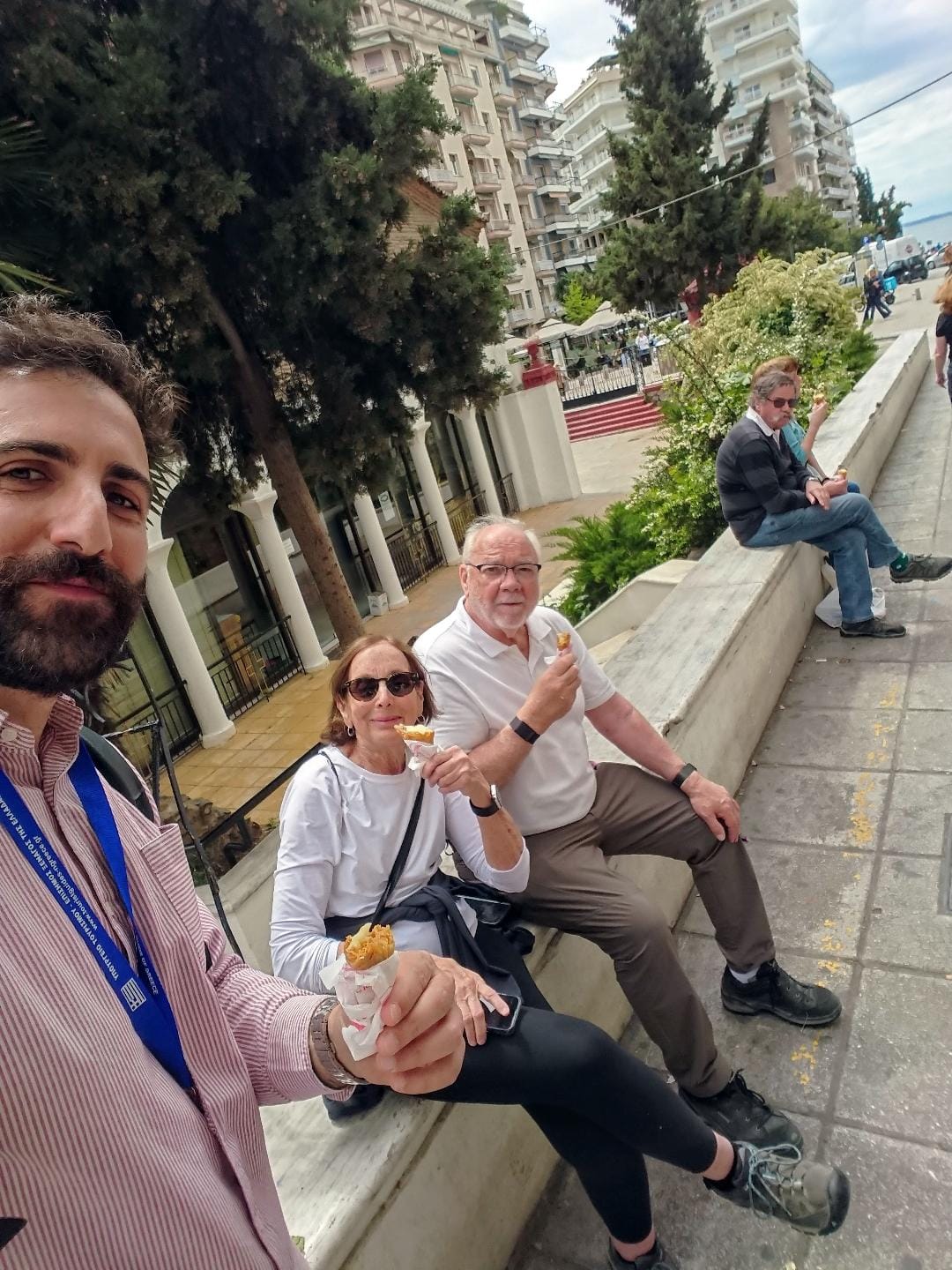 Panagiotis, the tour guide with two guests during a food tour